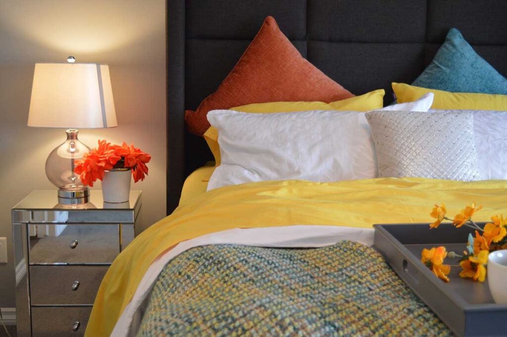 colorful bedroom linens and accent furniture pieces can really customize a space