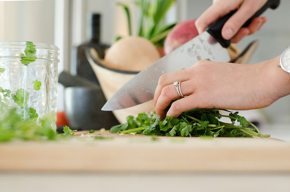 person chopping herbs